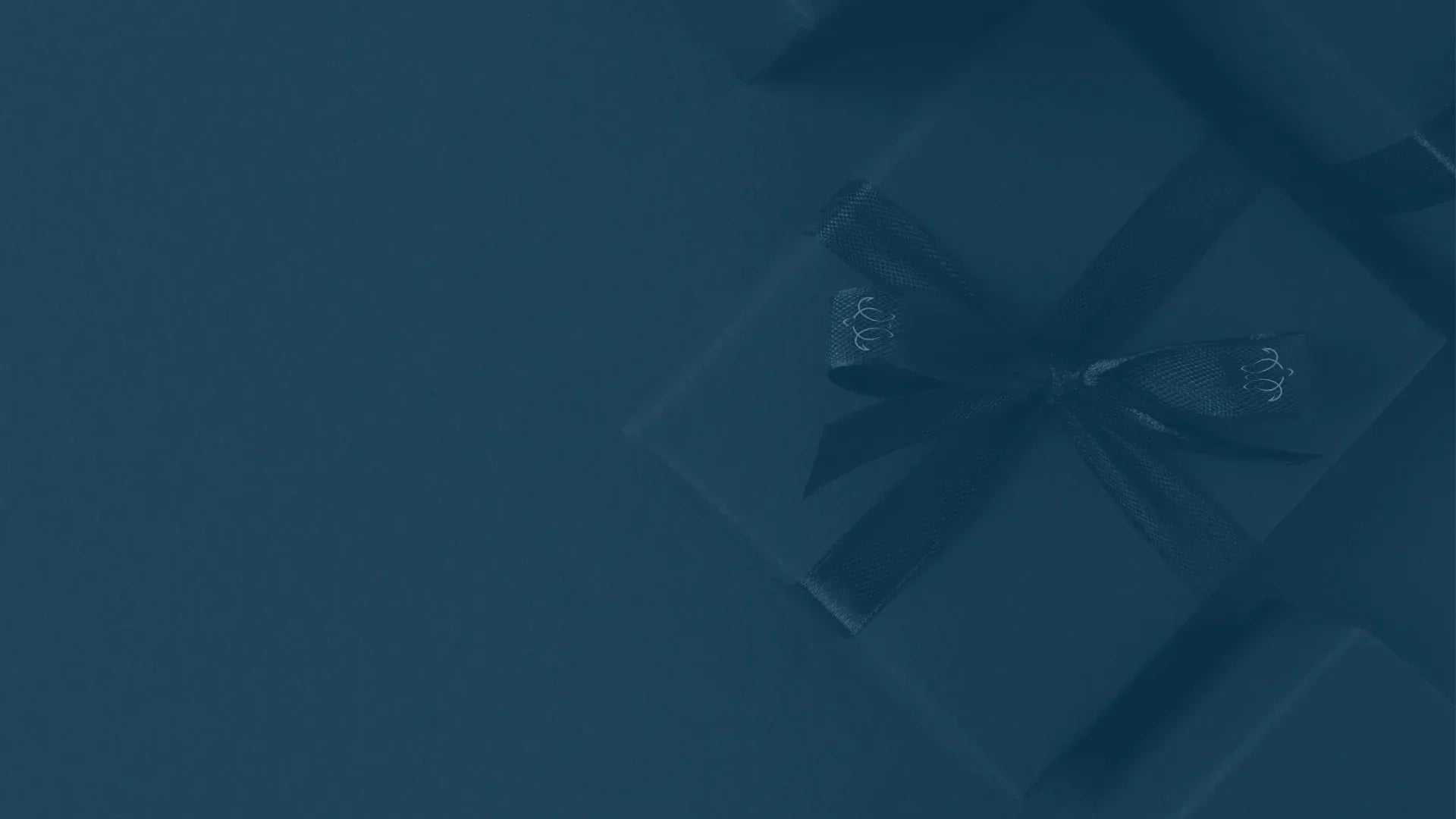 Honu gift box with a ribbon bow on a midnight blue background, a piece of jewellery to give as a gift