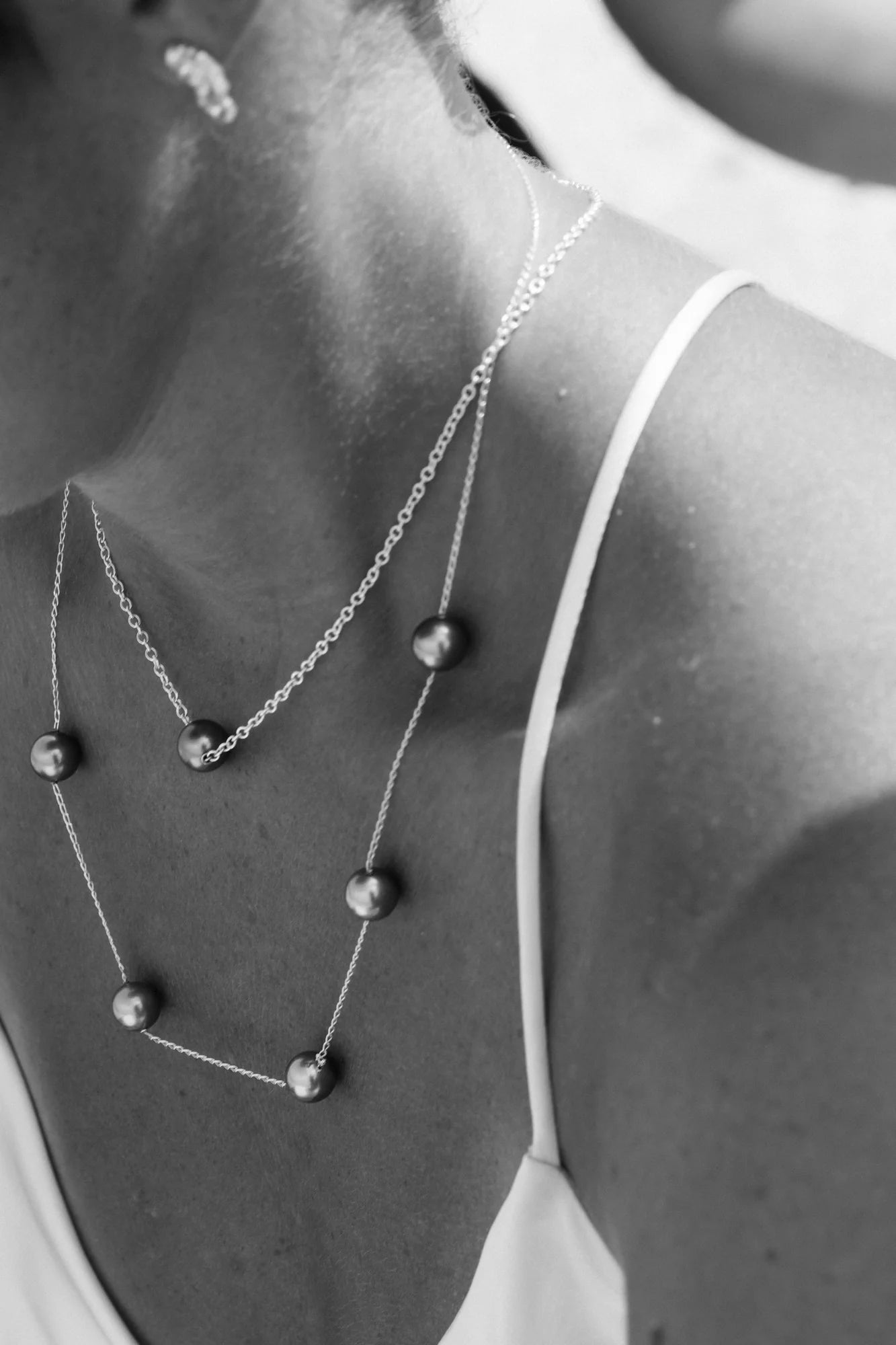 Collier Ancrage 3.14 et autres pièces Honu en gros plan en noir et blanc, de la collection Instinct, shooting Spring Summer 2026 | Honu