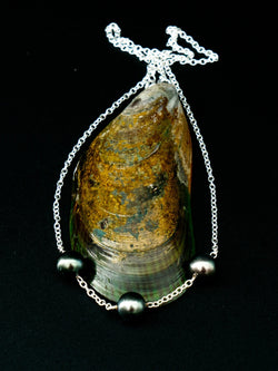 The Latitude 9.42 necklace, featuring three Tahitian pearls set on a shell, from the Instinct | Honu Collection